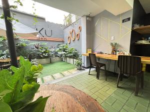 a room with a table and some plants in it at UKU INN in Medellín