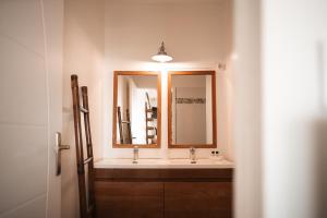 a bathroom with a sink and a mirror at Le M Hotel Marie Galante in Beauregard