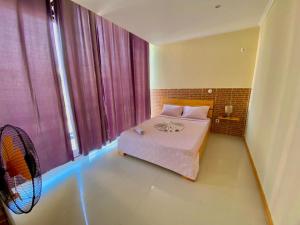 una camera con letto e ventilatore di African Guesthouse a Tarrafal