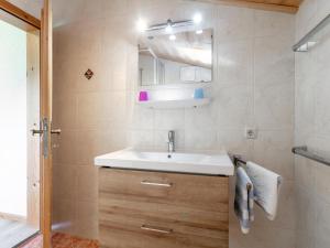 a bathroom with a sink and a mirror at Almruhe Alpbach in Alpbach +31 photos