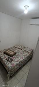 a bed sitting in a corner of a room at Pousada voo livre in Serra Talhada