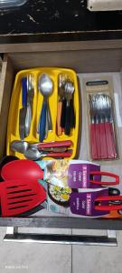 a yellow tray with utensils on a table at Pousada voo livre in Serra Talhada