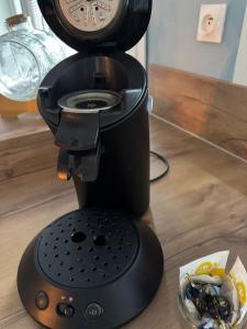 a black coffee maker sitting on top of a table at Loft Opale in Calais