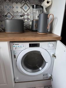 a washing machine with two pans on top of it at Loft Opale in Calais