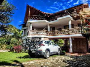 a car parked in front of a house with bikes on it at Mindo Suites - Toucans in Quito