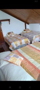 Postel nebo postele na pokoji v ubytování Mindo Suites