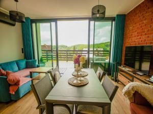 a living room with a table and a couch at A comfortable house in Kashubia for 5 people in Gołubie