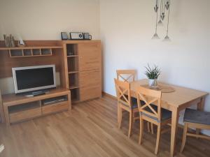 une salle à manger avec une table et une télévision dans l'établissement North Beach Pearl 2, à Norderney