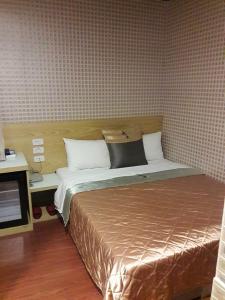 Voodi või voodid majutusasutuse Yung Feng Hotel toas