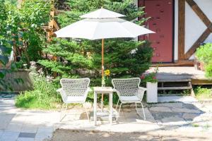 a table with two chairs and an umbrella at Yangpyeong Evergrove in Yangpyeong