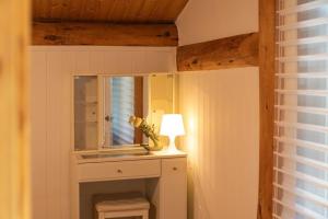 a bathroom with a mirror and a lamp on a table at Yangpyeong Evergrove in Yangpyeong +9 photos