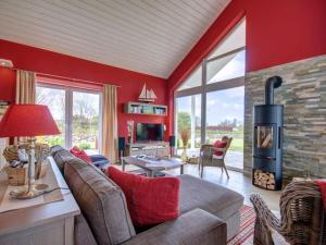 ein Wohnzimmer mit roten Wänden und einem Kamin in der Unterkunft Seepark - Holiday Home - Rügen in Vaschvitz