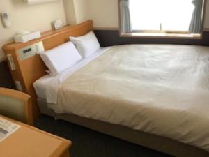 Postel nebo postele na pokoji v ubytování Crown Hills Tsuchiuraekihigashi