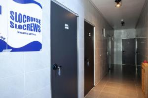 a hallway with two elevators and a door in a bathroom at Slowcruise in Gongju
