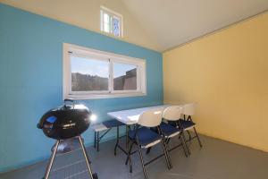 a room with a table and chairs and a window at Gangneung Solol Pension in Gangneung