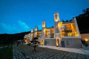 a large building with many windows at night at Buan Intaglio Pool Villa in Buan