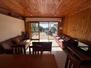 a living room with a couch and a table at Natural Lodge Maitencillo in Maitencillo