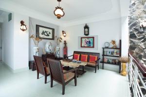 a living room with a dining room table and chairs at Gia Vien Homestay in Hoi An