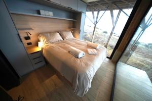 En eller flere senge i et værelse på Patagonia 360