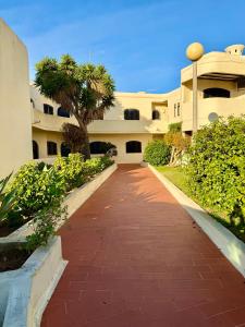 a red brick walkway in front of a building at Casa Flor de Sal Apartment in Carvoeiro