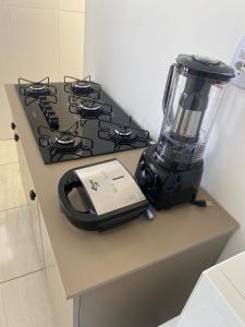 a blender sitting on a counter next to a stove at Flat aconchego PNz in Petrolina
