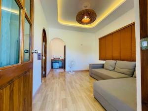a living room with a couch and a ceiling at Baan Sangchan in Ko Kood
