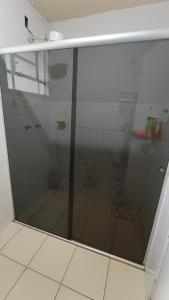 a shower with a glass door in a bathroom at Casatemporadapadilha in Olímpia +14 photos