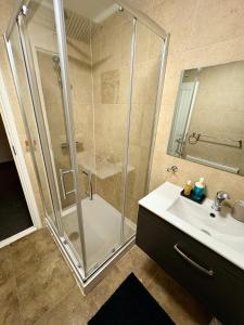 a bathroom with a shower and a sink at Bright and Spacious 2 Bed Flat Sleeps 5 in Nottingham +14 photos