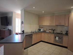 a kitchen with wooden cabinets and a counter top at Annesley Central in Echuca