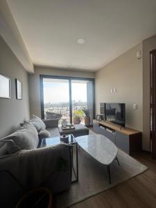 un soggiorno con un divano e un tavolo di Depa - Estadio Guadalajara - Ciudad Judicial a Guadalajara