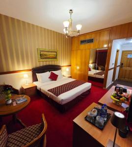 a hotel room with a bed and a table at Golden California Hotel in Dubai +15 photos