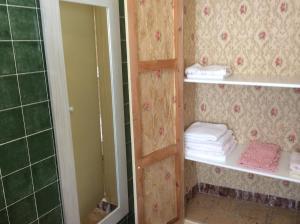 a bathroom with a shower and shelves with towels at Ca Bienvenida in Miramar +36 photos