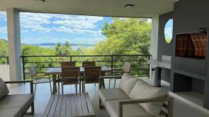 a living room with a table and chairs and a balcony at Escapada Premium en San Bernardino! Toledo House in San Bernardino