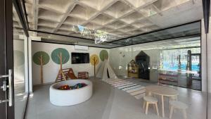 a living room with a table and chairs and a room with trees on the wall at Escapada Premium en San Bernardino! Toledo House in San Bernardino