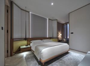 a bedroom with a large white bed in it at Soori Penang in George Town