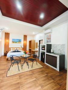 a bedroom with a bed and a table and chairs at O k Chawkoh Bungalow in Ko Lanta