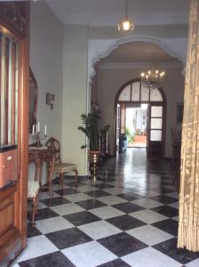 a hallway with a black and white checkered floor at Ca Bienvenida in Miramar