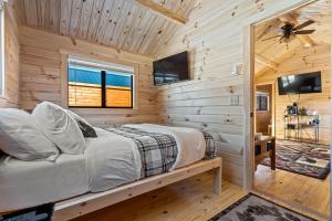 a bedroom with a bed in a wooden cabin at Cozy ski cabin #3, 3 beds in Bethel