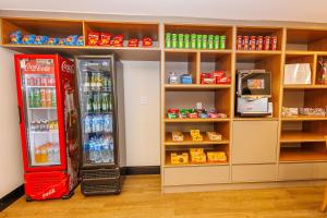 a room with two cocacola refrigerators and shelves at Hotel Move BH in Belo Horizonte