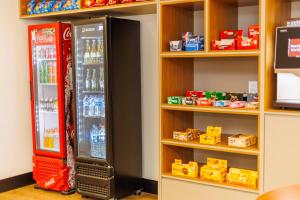 a store with two soda machines in a room at Hotel Move BH in Belo Horizonte