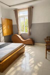a bedroom with a bed and a window at 10h Hotel in Ho Chi Minh City