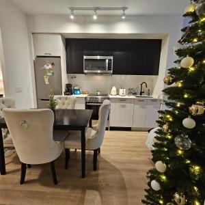 ein Esszimmer mit Weihnachtsbaum und eine Küche in der Unterkunft Stockyards in Toronto