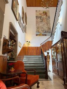 a room with stairs with a painting on the wall at Hotel Luna in Guanajuato