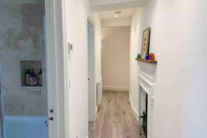 a hallway with a fireplace in a room at New contemporary apartment in centre of Tetbury in Tetbury