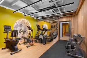 a gym with treadmills and cardio equipment in a room at Metropole, Bangkok, a Tribute Portfolio Hotel in Bangkok