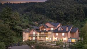 a large house on the side of a hill at yangpyeong beulleosseom pet spa pension in Yangpyeong