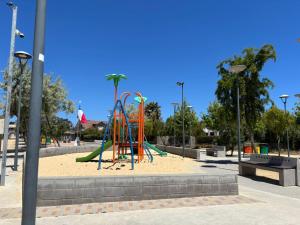 une aire de jeux avec un toboggan dans un parc dans l'établissement Casa en el quisco 10 personas con piscina, à El Quisco