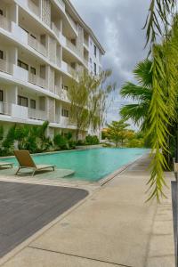 a swimming pool in front of a building at Rose & Golf at Rose Apple Square in Siem Reap