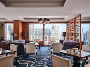 a hotel lobby with tables and chairs and a large window at The Langham, Shanghai, Xintiandi in Shanghai