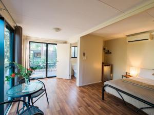 a bedroom with a bed and a glass table at Breeze Holiday Parks - Mary River in Marrakai +68 photos